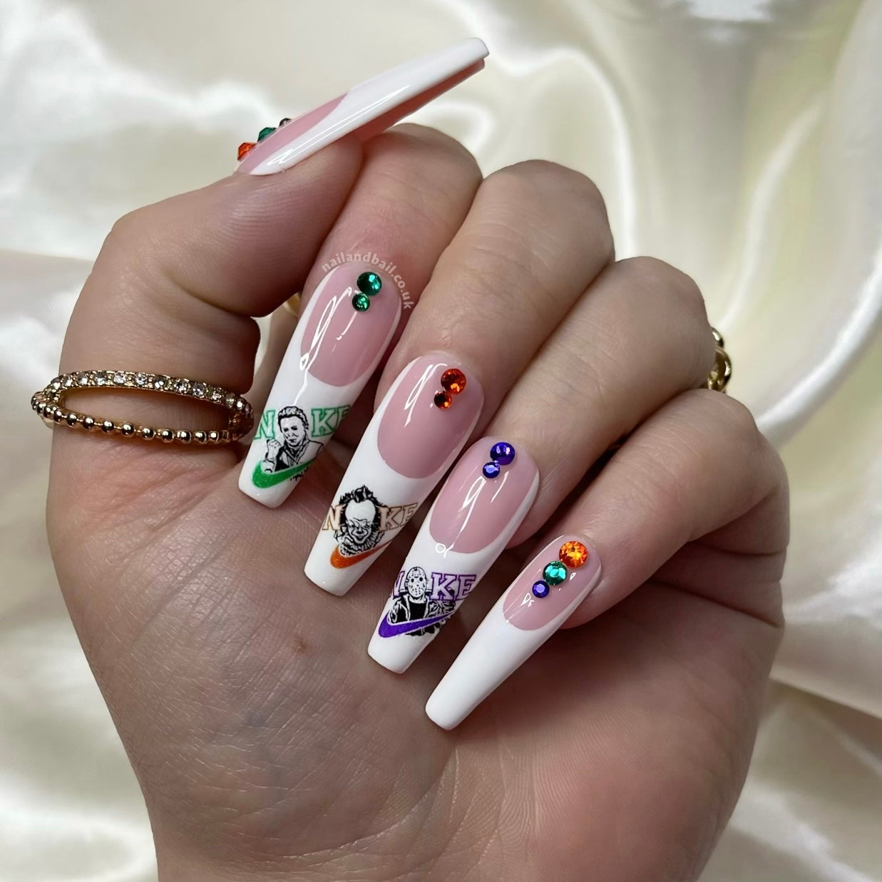 Unleash your bold side with “Just Kill It”. These press-on nails feature swoosh-inspired designs with horror character details and are accented with orange, purple, and green crystals. Perfect for adding an edgy, stylish touch to any look.